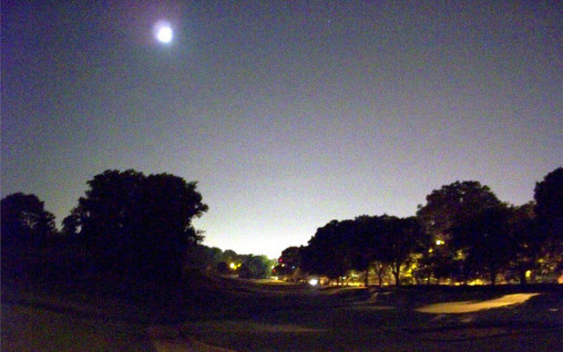 Golf course at night with moon