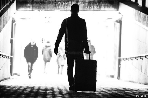 Man with roller suitcase in airport